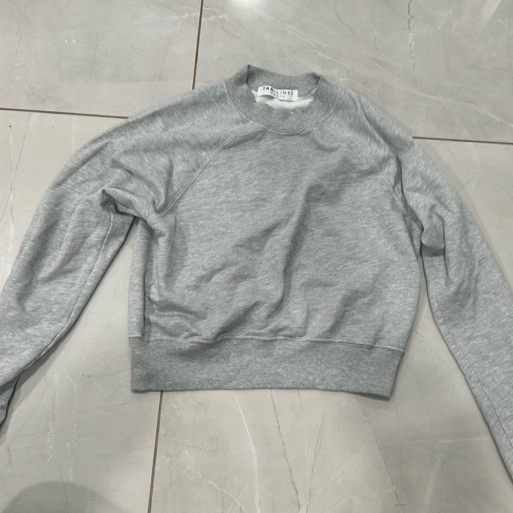 This is a grey crew neck from Tan Plus Lines by Silvan Ayla.